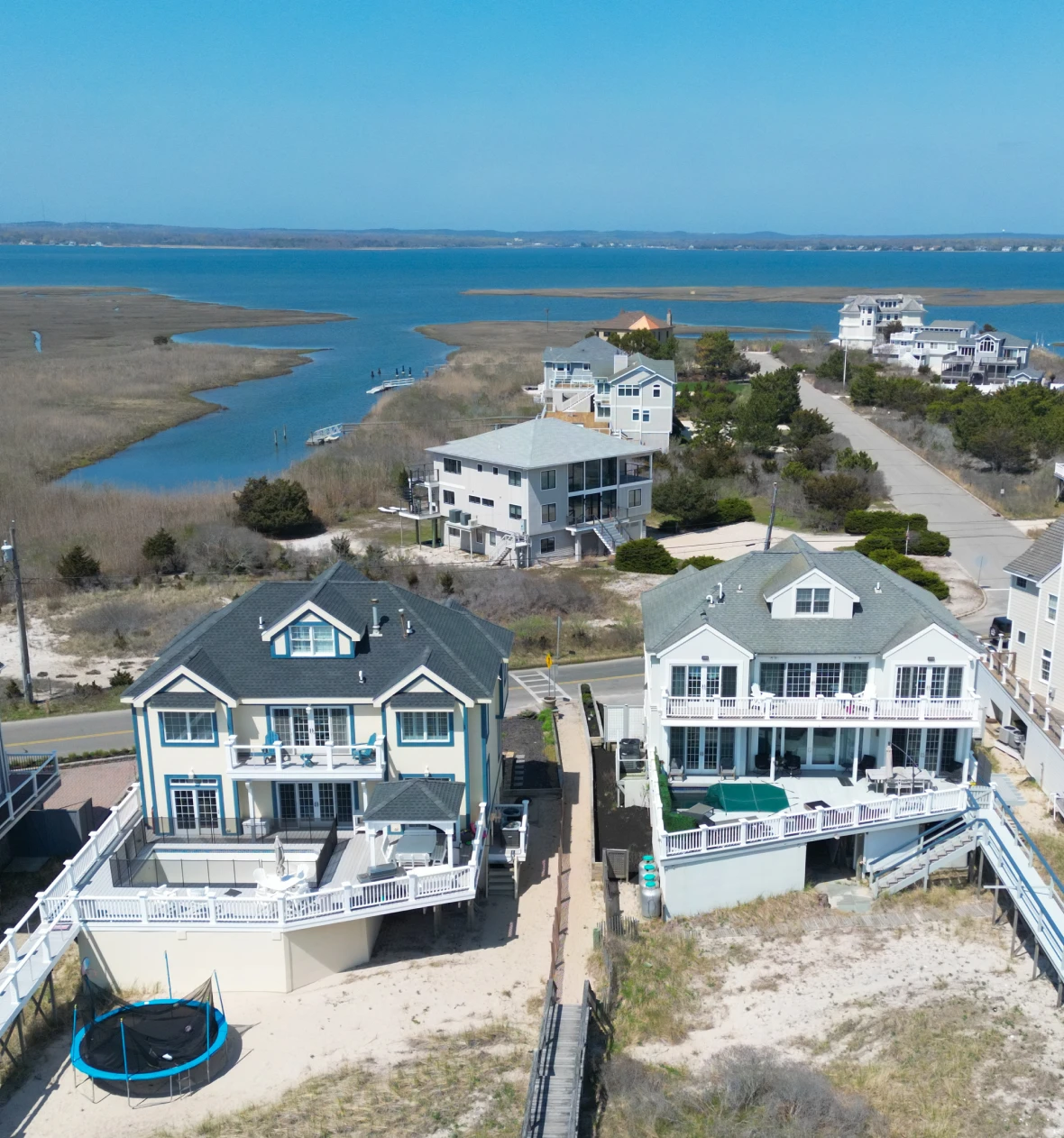 Beachfront houses overlooking a serene coastal landscape.